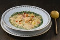 Fresh creamy salmon fish soup with potatoes, carrots, broccoli, peppers and onions in a ceramic plate on a wooden table, closeup. Royalty Free Stock Photo