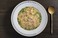 Fresh creamy salmon fish soup with potatoes, carrots, broccoli, peppers and onions in a ceramic plate on a wooden table. A Royalty Free Stock Photo