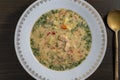 Fresh creamy salmon fish soup with potatoes, carrots, broccoli, peppers and onions in a ceramic plate on a wooden table. A Royalty Free Stock Photo