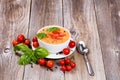 Fresh creamy tomato soup with basil leaves on rustic wooden boar Royalty Free Stock Photo