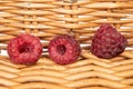 Fresh crimson raspberry with braided rattan