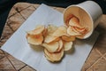 Fresh Crispy potato chips on a wooden background, top view. Royalty Free Stock Photo