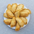 Fresh, crispy, puff pies on a white plate. View from above