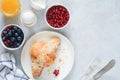 Fresh croissant, berries, honey and berries on table. Top view Royalty Free Stock Photo