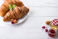 Fresh Croissant with berries and jam for breakfast isolated on white wooden background , copy space Royalty Free Stock Photo