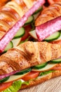 Fresh croissant with salami, chesse and vegetables. Royalty Free Stock Photo