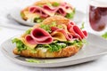 Fresh croissant or sandwich with salad, ham and cheese on light  background Royalty Free Stock Photo