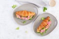 Fresh croissant or sandwich with salad, ham and cheese on light  background. Top view Royalty Free Stock Photo