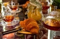 Fresh croissant with tea cup and jam in cafe