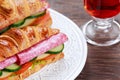 Fresh croissant with vegetables, salami, chesse and tea Royalty Free Stock Photo