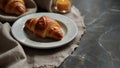 Fresh croissants on cloth on a trendy marble table.