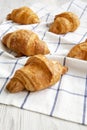 Fresh Croissants On Cloth On White Wooden Background, Low Angle View. Close-up.