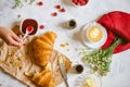 Fresh croissants, coffee, jam, butter on the table. Royalty Free Stock Photo