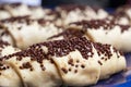 Fresh croissants decorated with chocolate chips are prepared for baking in the oven Royalty Free Stock Photo