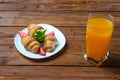 Fresh croissants and a glass of orange juice on a wooden table. Royalty Free Stock Photo