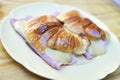 Fresh croissants with ham and cheese on plate