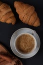 Fresh croissants with jam isolated against dark background