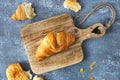 Fresh croissants lie on a cutting board, top view. Fresh traditional french homemade pastries for breakfast