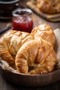 Fresh croissants in a wooden bowl