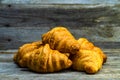 Fresh croissants on wooden table and background - French breakfast Royalty Free Stock Photo