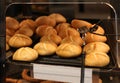 Fresh crusty bread rolls or buns on the showcase of the bakery in the supermarket, with price label Royalty Free Stock Photo