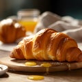 Fresh crusty croissant on a wooden board with butter and honey, breakfast food. Freshly oven-baked golden croissant on wooden