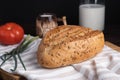 Fresh homemade rye bread, tomato, bunch onion, clay mug and bottle of milk on wooden cutting board Royalty Free Stock Photo