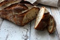 Fresh and crusty sliced bread on rustic table Royalty Free Stock Photo