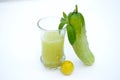 The fresh cucumber juice in the glass and green cucumber, lamon ,mint  isolated on white background Royalty Free Stock Photo