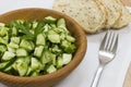 Fresh cucumber salad in wooden bowl