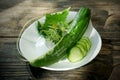 Fresh cucumber  the white plate on wooden Royalty Free Stock Photo