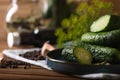 Fresh cucumbers and other ingredients prepared for canning on wooden table, closeup. Space for text Royalty Free Stock Photo