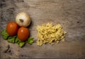 Fresh culinary ingredients for Italian pasta, mafalda, tomato, onion