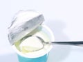 Curd with spoon on opened container