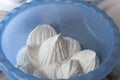 Fresh curd in the shape of a Bizet or marshmallow in a blue bowl. Stuffing for baking or just a healthy breakfast. creamy cottage