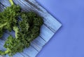 Fresh curly kale leaves on wooden table