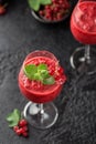 Fresh currant cocktail. Fresh summer cocktail with red currant and ice cubes. Glass of red currant mojito Royalty Free Stock Photo