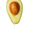 Fresh cut avocado with dripping cooking oil on white background Royalty Free Stock Photo