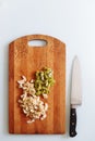 Fresh cut of banana and kiwi on wooden chopping board with knife. isolated on white, from above, flat lay Royalty Free Stock Photo