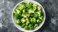 Fresh cut broccoli florets on a white plate