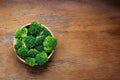 Fresh cut broccoli in wooden bowl on rustic wooden background Royalty Free Stock Photo