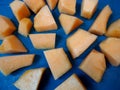 Fresh cut Cantaloupe in a pattern on blue