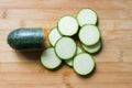 Fresh cut green zucchini rounds on wooden board. Cooking vegetables Royalty Free Stock Photo