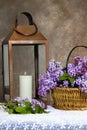 Fresh-cut Lilac Flowers in Basket Next to Copper Lantern Royalty Free Stock Photo