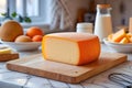 A fresh cut of Mahon cheese displayed elegantly in a modern, sunlit kitchen