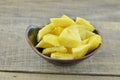 Fresh cut pieapple in black bowl on wooden table Royalty Free Stock Photo