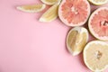 Fresh cut pomelo fruits on pink background, flat lay. Space for text Royalty Free Stock Photo