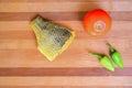 Fresh fish, cleaned with turmeraic, prepared for baking in the oven with herbs and seasoning on a wooden board.