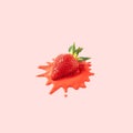 Fresh cut strawberry in a red melting cream on pink background Royalty Free Stock Photo
