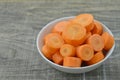 Fresh cut thick carrots on bowl on wooden Royalty Free Stock Photo